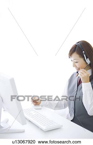 Smiling businesswoman wearing headset View Large Photo Image Stock Image - Smiling businesswoman wearing headset. Fotosearch