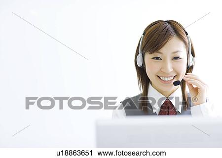 Smiling businesswoman wearing headset View Large Photo Image Stock Image - Smiling businesswoman wearing headset. Fotosearch