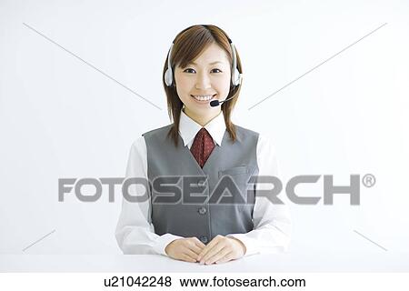 Stock Photo - Smiling businesswoman wearing headset. Fotosearch