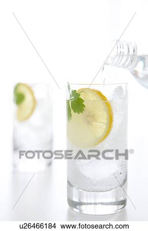 Picture - Soda water being poured into glass. Fotosearch