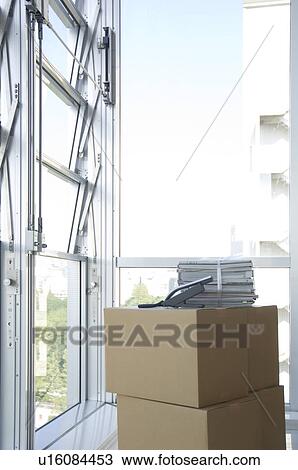 Stock Image - Stack of cardboard boxes and magazines. Fotosearch