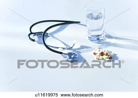 Stock Photography - Stethoscope, glass of water and pills. Fotosearch