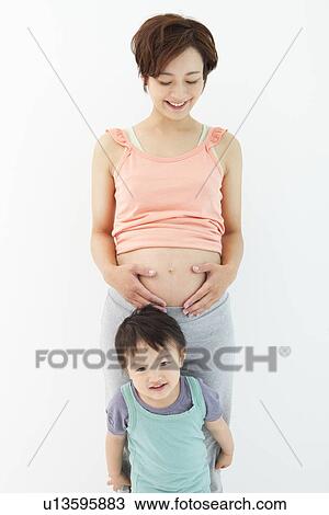Studio portrait of pregnant woman and her preschool age son View Large Photo Image Stock Image - Studio portrait of pregnant woman and her preschool age son. Fotosearch