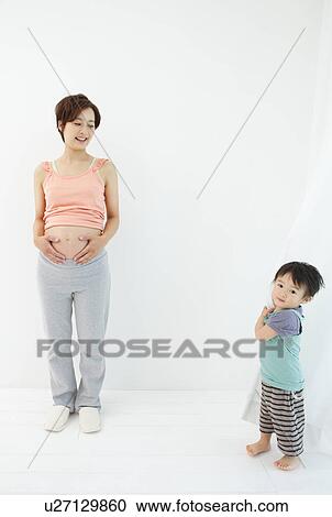 Studio portrait of pregnant woman and her preschool age son View Large Photo Image Stock Image - Studio portrait of pregnant woman and her preschool age son. Fotosearch