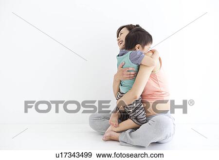 Studio portrait of pregnant woman hugging her preschool age son View Large Photo Image Stock Photo - Studio portrait of pregnant woman hugging her preschool age son. Fotosearch