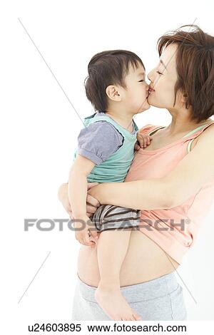 Studio portrait of pregnant woman kissing her preschool age son View Large Photo Image Stock Photography - Studio portrait of pregnant woman kissing her preschool age son. Fotosearch