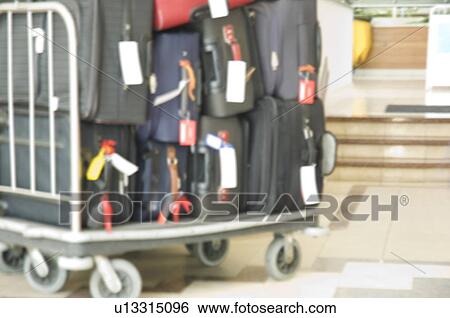 Stock Photograph - Suitcases on a luggage cart. Fotosearch