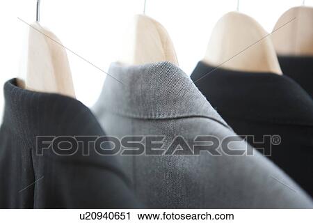 Stock Image - Suits on a clothes rack. Fotosearch