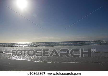 Sun shining over beach View Large Photo Image Stock Photo - Sun shining over beach. Fotosearch