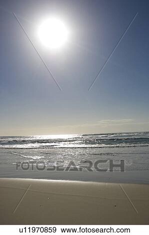 Sun shining over beach View Large Photo Image Stock Photo - Sun shining over beach. Fotosearch