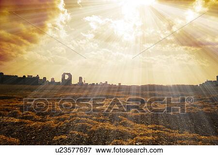 Stock Photo - Sunbeams shining on cityscape. Fotosearch