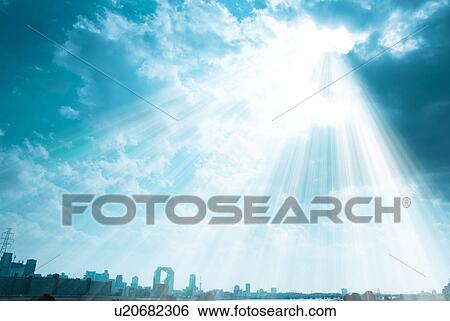Stock Photograph - Sunbeams shining on cityscape. Fotosearch