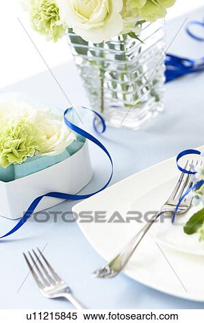 Stock Photography - Table setting with flowers and blue ribbon. Fotosearch