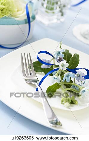 Table setting with flowers and blue ribbon View Large Photo Image Stock Photography - Table setting with flowers and blue ribbon. Fotosearch