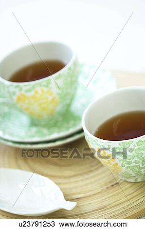 Stock Image - Tea cup on table setting. Fotosearch