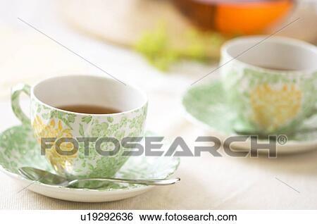 Stock Photograph - Tea cup on table setting. Fotosearch