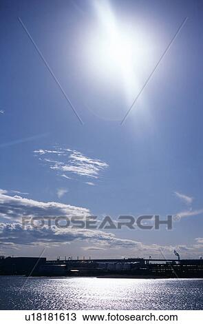 Stock Image - The sun and the water surface to reflect. Fotosearch