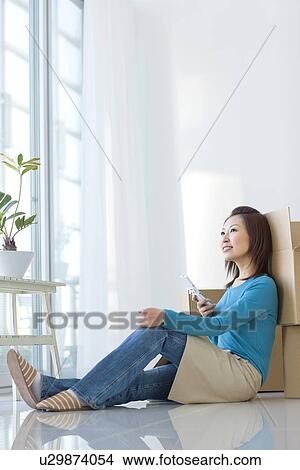 Picture - The woman under move work with a mobile phone. Fotosearch