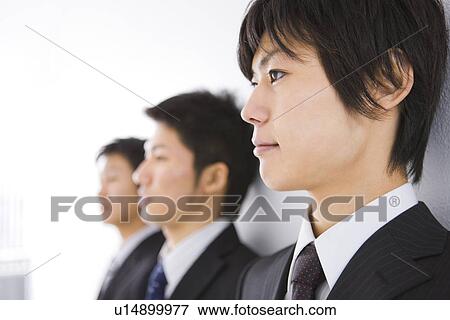 Three businessmen standing in a line View Large Photo Image Stock Photo - Three businessmen standing in a line. Fotosearch