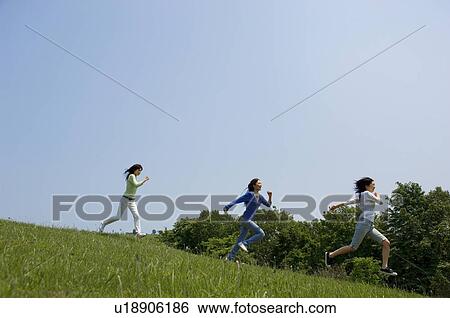 Stock Photograph - Three young people running. Fotosearch