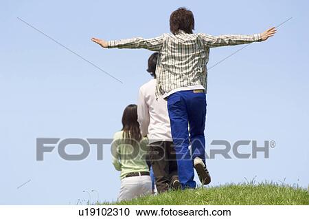 Stock Image - Three young people walking. Fotosearch