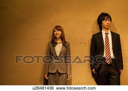 Two businesspeople standing side by side View Large Photo Image Stock Photograph - Two businesspeople standing side by side. Fotosearch