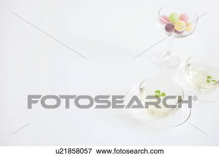 Stock Photo - Two cups of herbal tea and a glass of candy. Fotosearch