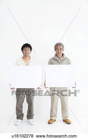 Stock Photo - Two men holding up blank signs. Fotosearch