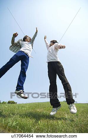 Picture - Two young men doing a high five. Fotosearch