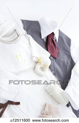 Stock Image - Uniform and baby clothes. Fotosearch