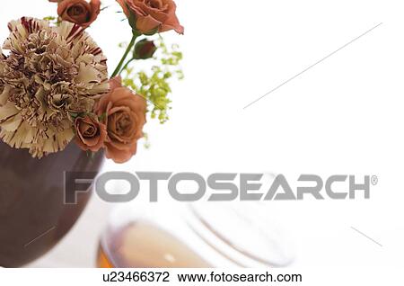 Stock Image - Vase of flowers and teapot. Fotosearch