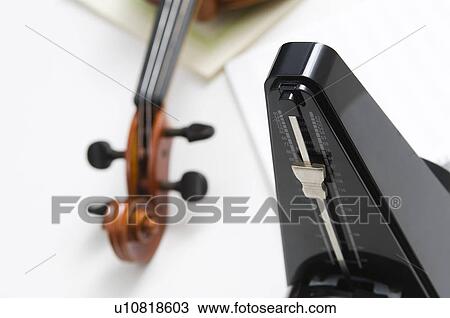 Stock Image - Violin and a metronome. Fotosearch