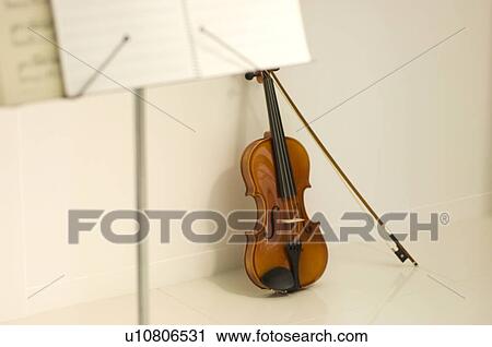 Stock Image - Violin and sheet music on a stand. Fotosearch