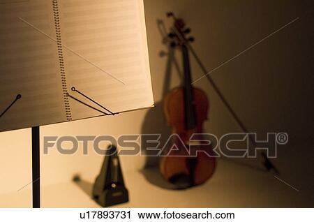 Violin, metronome and sheet music on a stand View Large Photo Image Stock Image - Violin, metronome and sheet music on a stand. Fotosearch