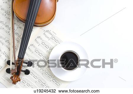 Stock Image - Violin, sheet music and a coffee cup. Fotosearch