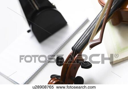 Stock Photography - Violin, sheet music and a metronome. Fotosearch