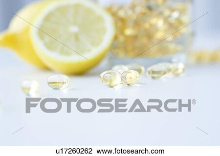 Stock Image - Vitamin capsules and lemons. Fotosearch