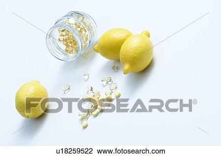 Stock Image - Vitamin capsules and lemons. Fotosearch