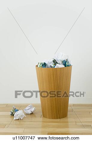 Wastepaper bin overflowing with crumpled paper View Large Photo Image Stock Photo - Wastepaper bin overflowing with crumpled paper. Fotosearch