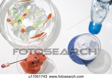 Watermelon in a dish, goldfish in a bowl and water being poured into glass View Large Photo Image Stock Image - Watermelon in a dish, goldfish in a bowl and water being poured into glass. Fotosearch