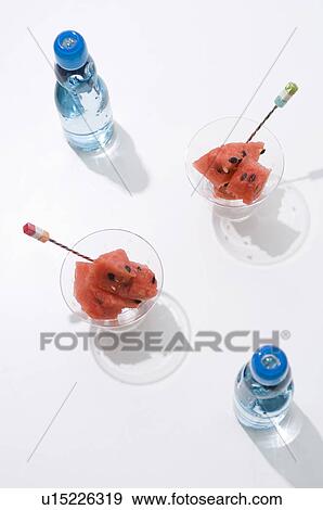 Stock Photo - Watermelon in dishes and a bottles of water. Fotosearch