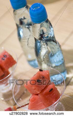 Watermelon in dishes and a bottles of water View Large Photo Image Stock Photo - Watermelon in dishes and a bottles of water. Fotosearch