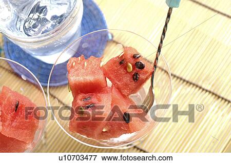 Watermelon in dishes and a glass of water View Large Photo Image Stock Photo - Watermelon in dishes and a glass of water. Fotosearch