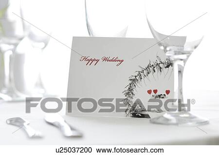 Stock Image - Wedding card at a place setting. Fotosearch