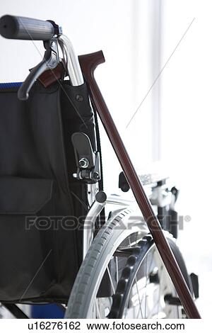 Stock Image - Wheelchair and a cane. Fotosearch