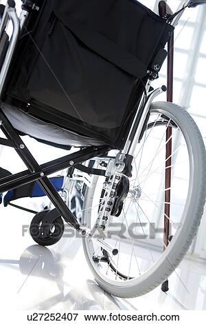 Wheelchair and a cane View Large Photo Image Stock Photo - Wheelchair and a cane. Fotosearch