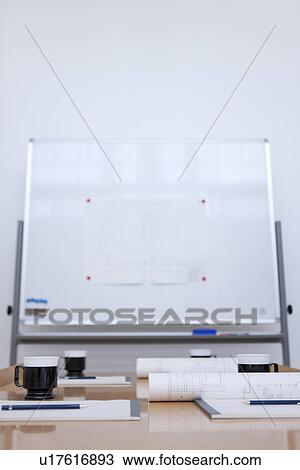 Stock Image - Whiteboard and table in empty board room. Fotosearch