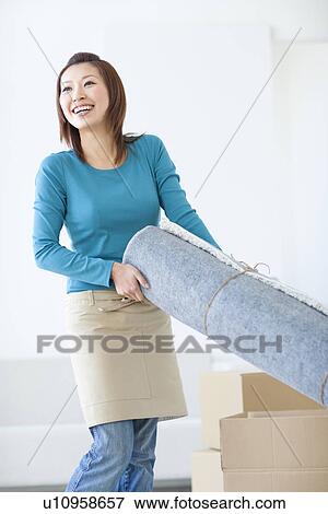 Woman carrying rug View Large Photo Image Stock Photo - Woman carrying rug. Fotosearch