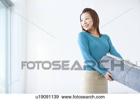 Woman carrying rug View Large Photo Image Stock Photo - Woman carrying rug. Fotosearch