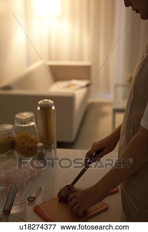 Woman cutting bread View Large Photo Image Stock Photo - Woman cutting bread. Fotosearch